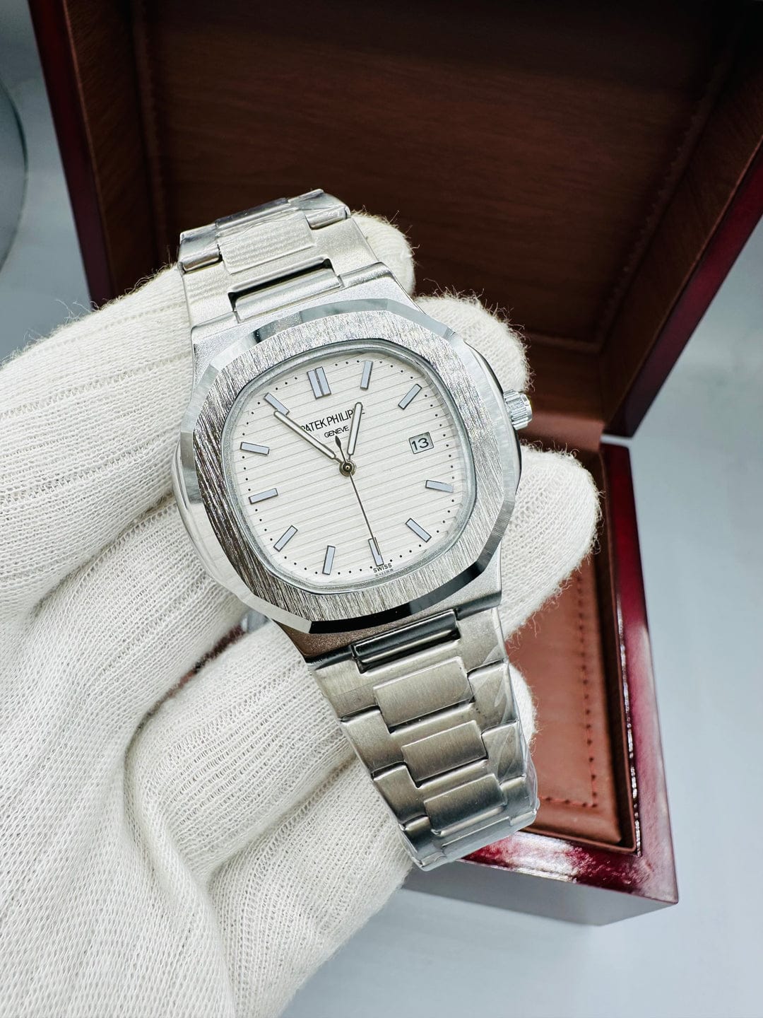the Patek Philippe Silver Watch with white dial and date display