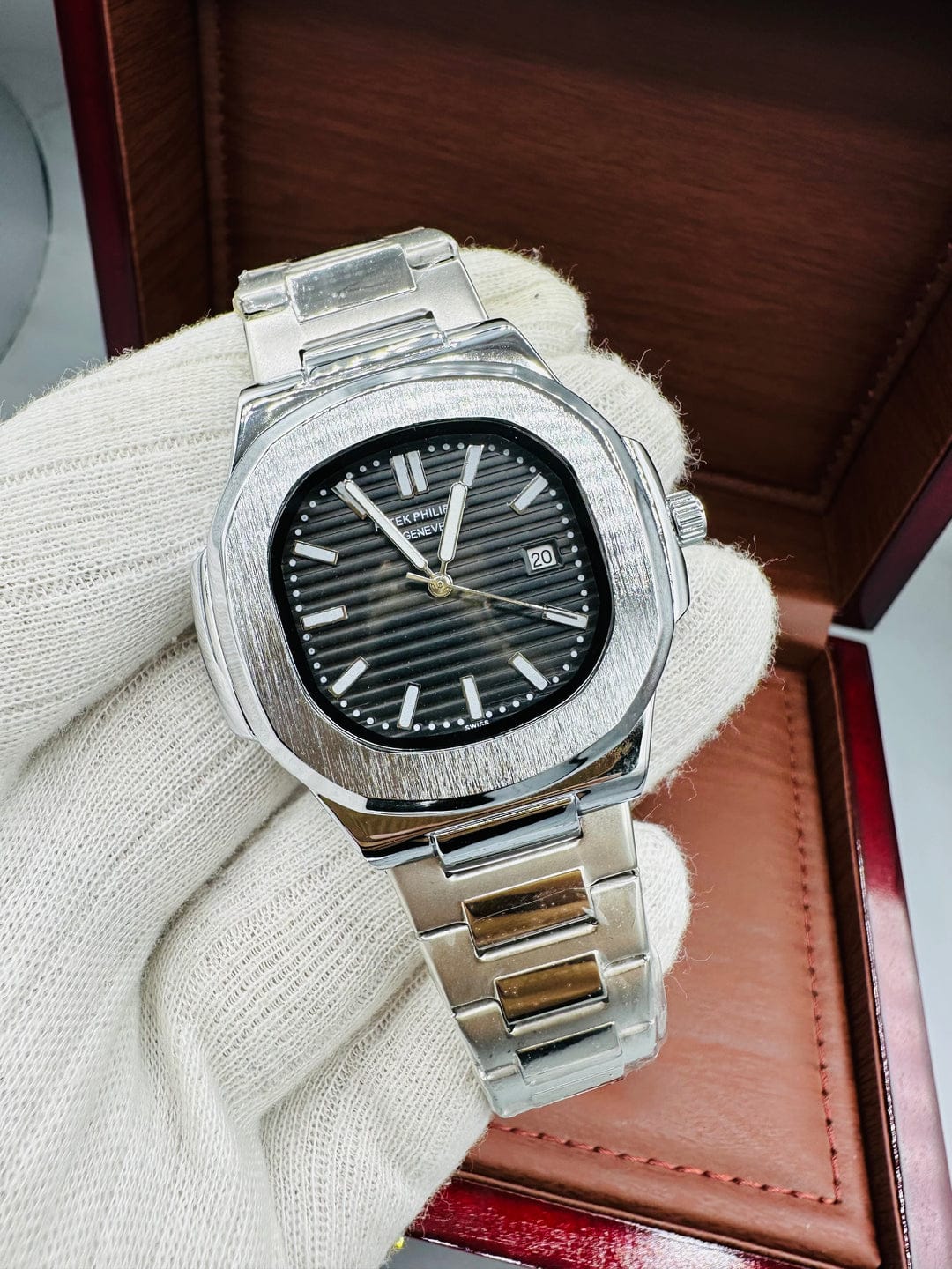 the Patek Philippe Silver Watch with bold Black Dial & Date. 
